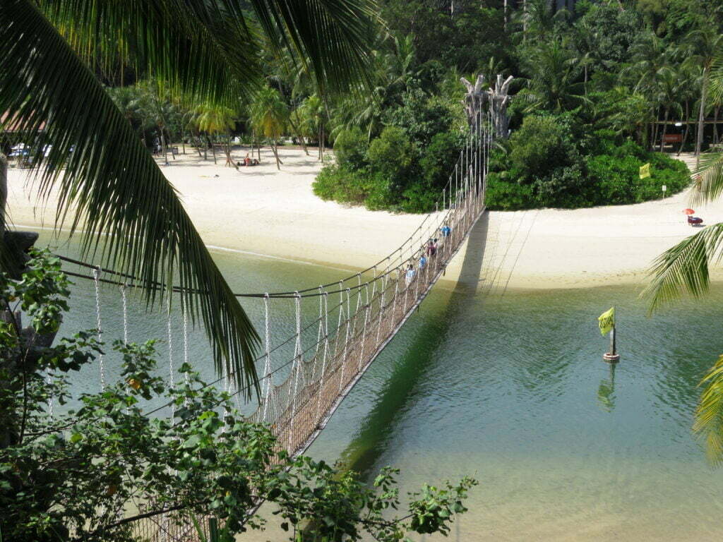 group of people crossing the bridge, sentosa beach